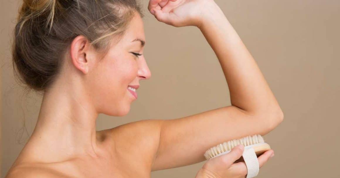 woman dry brushing arms