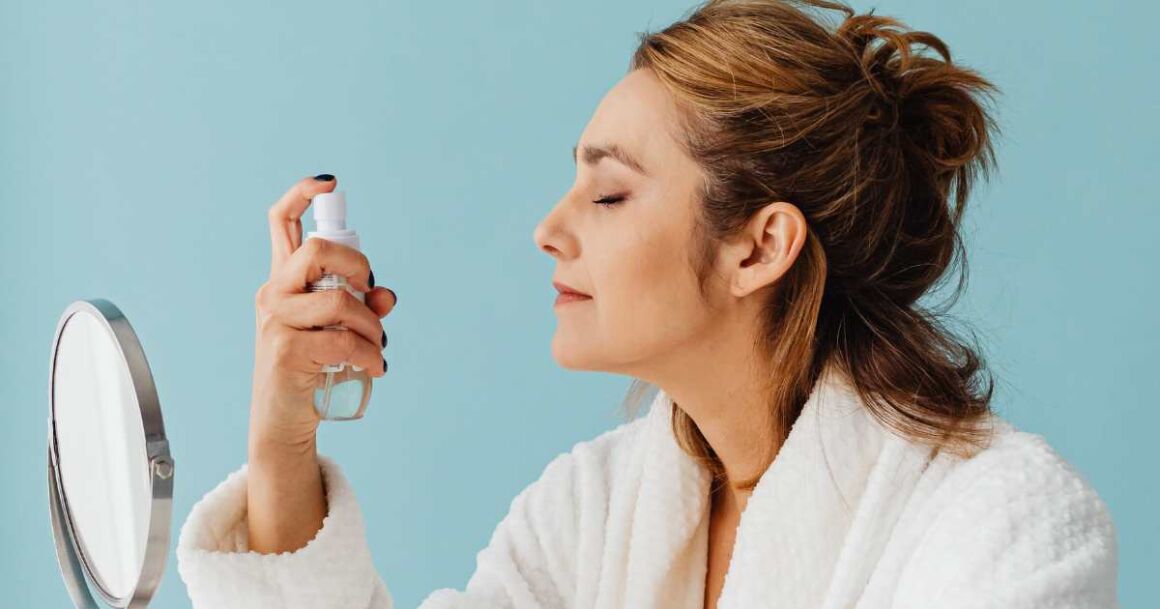 woman spraying the best drugstore makeup setting sprays