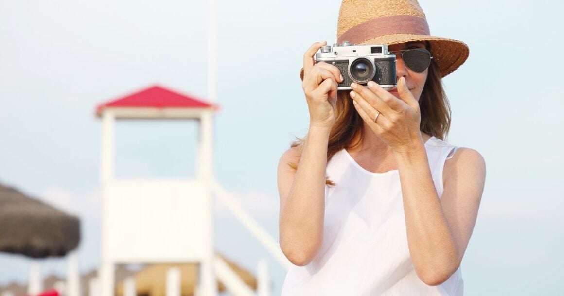 Woman taking photo at beach