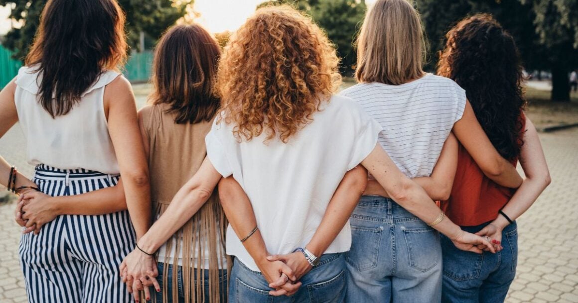 Women standing together, playful poses.
