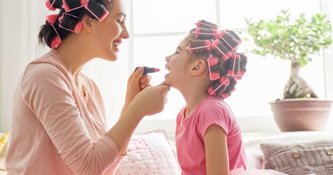 Mother and daughter bonding with curlers.